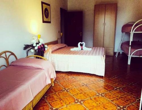 a bedroom with two beds with a weddingvisor on them at Agriturismo Castanito in Vico Equense