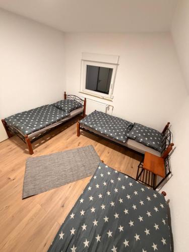 a room with two beds and a television in it at Workhome A2 zu 6 in Lünen