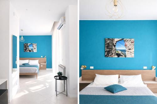 a bedroom with blue walls and a bedroom with a bed at Maqueda Suites in Palermo