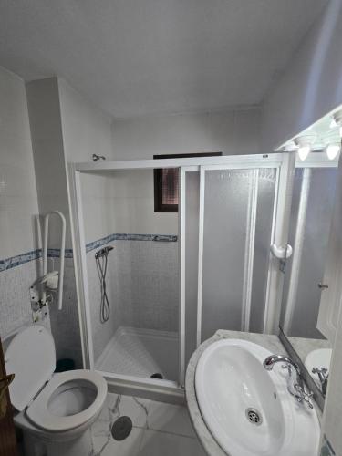a bathroom with a shower and a toilet and a sink at Bellavista in La Línea de la Concepción