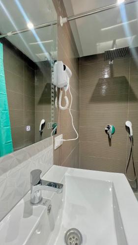 a bathroom with a sink and a mirror at Lovely studio 4th floor No Elevator in El Gouassem