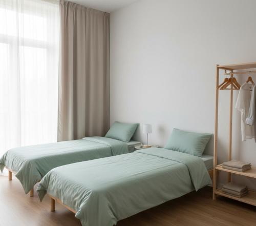 a room with two beds and a window at Norvia Otel in Konya