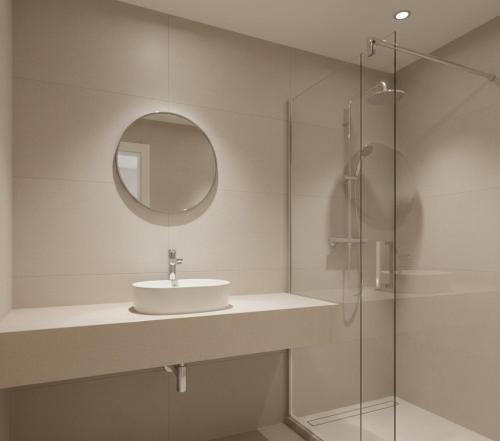 a white bathroom with a sink and a shower at Norvia Otel in Konya