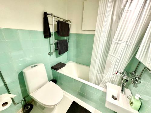 een badkamer met toilet, bad en wastafel bij DP Apartments Vaasa III in Vaasa