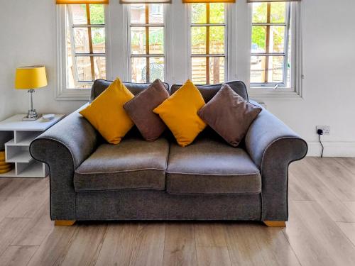 a couch with pillows on it in a living room at The Haven Lodge in Clifton