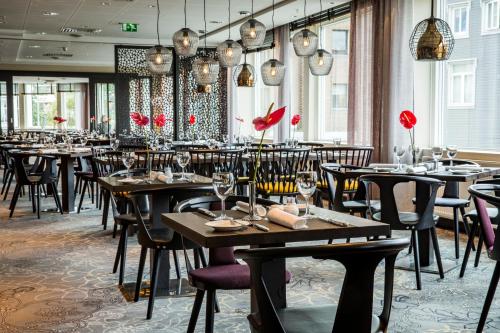 a dining room filled with tables and chairs at Radisson Blu Hotel Tromsø in Tromsø