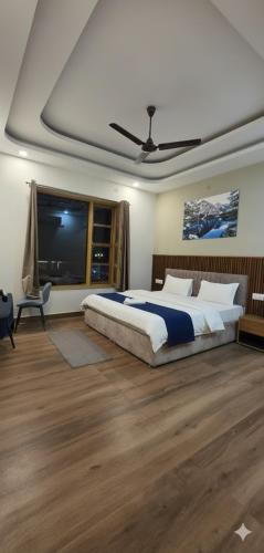 a bedroom with a bed and a flat screen tv at Devlok Homes in Rishīkesh