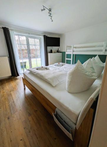 a large bed with white sheets and pillows in a bedroom at Apartment Rehblick Hohenwarth in Hohenwarth
