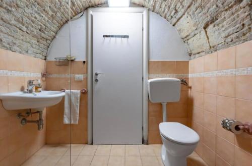 a bathroom with a toilet and a sink at Sa domu pitticca Cavour in Cagliari