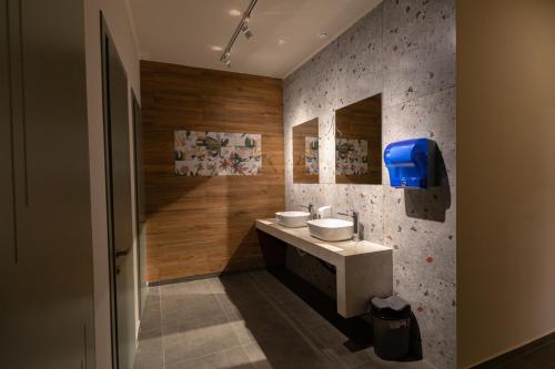 a bathroom with a sink and two toilets at Nabada Hotel - Riverside in Ozurgetʼi