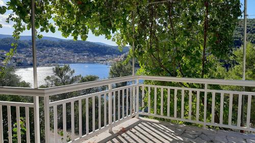 a white porch with a view of the water at Apartment ZenPunta in Pučišća
