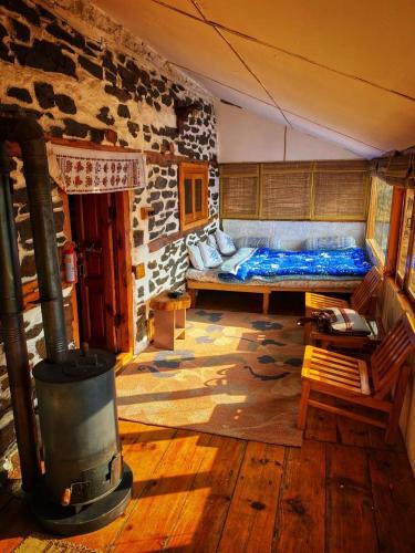 a room with a bed and a fireplace in it at The Himalayan Home in Nagar
