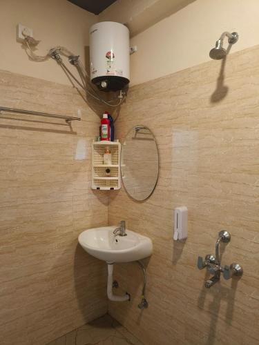 a bathroom with a sink and a mirror at Cleanslate homestay in Guwahati