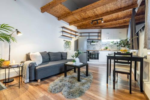 a living room with a couch and a table at Apartmán U Hluboké studny in Rakovník