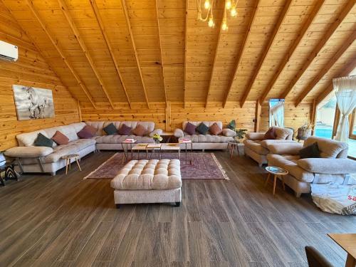 a large living room with couches and a wooden ceiling at أكواخ كيفاء الريفية in Tabuk