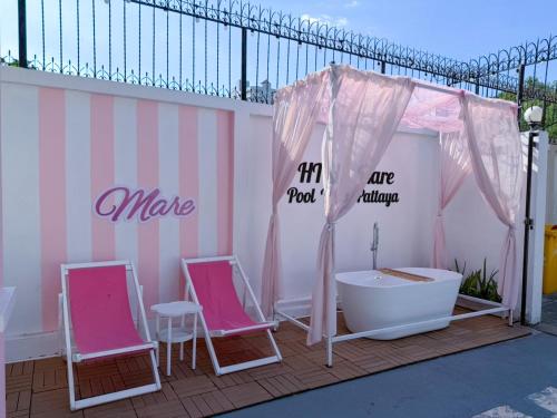 a room with two pink chairs and a bath tub at Home to my heart mare pool villa in Jomtien Beach