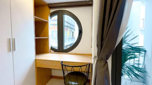 a room with a mirror and a desk with a chair at Lunaria Maison - Local Side in Ho Chi Minh City