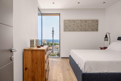 a bedroom with a bed and a large window at Rotolo Roof 21 5C in Catania