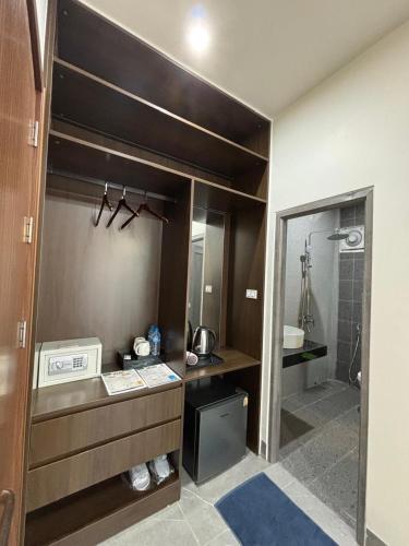 a bathroom with a sink and a shower at Tulip Elegant Riverside Hotel in Vang Vieng