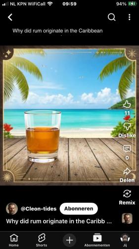 a picture of a glass of drink on a table with the beach at Enjoy Sailing from Hoorn to Dartmouth 1 May Till 13 May and from 15 May to Lissabon arriving 27 May or 29 Mai to Algarve Vilamoura arriving 10 June in Medemblik