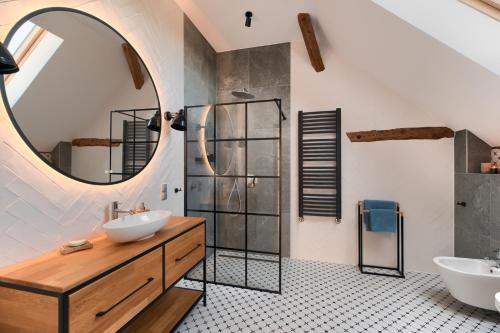a bathroom with two sinks and a mirror at Stodola Rybojady in Rybojady