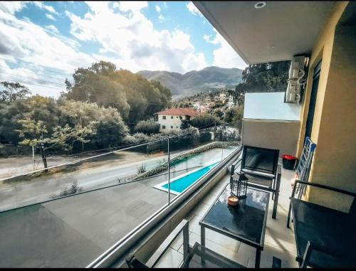 a balcony with a view of a swimming pool at EXOTIC LUXURY APARTMENT in Nikiana