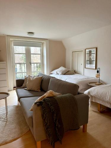 a living room with a couch and a bed at Peaceful Retreat in Hillerød