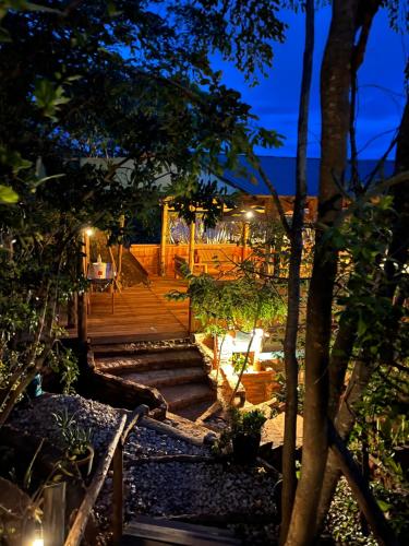 a set of stairs leading to a deck at night at Aika Sunrise - Your Home in the Hills in Iringa