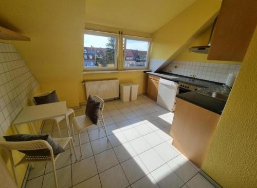a kitchen with a table and chairs and a counter top at Süße Marie 6 in Karlsruhe