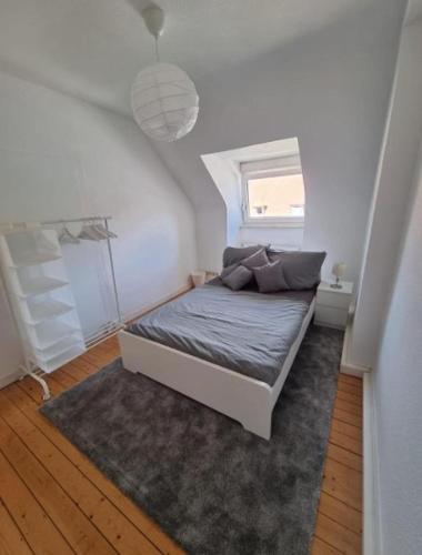 a bed in a small room with a window at Süße Marie 6 in Karlsruhe