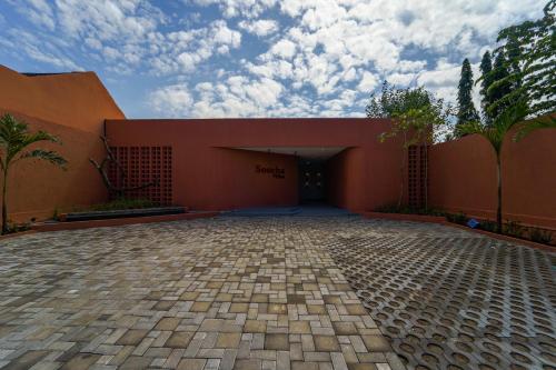 a building with a parking lot in front of it at Soocha Villas in Yogyakarta