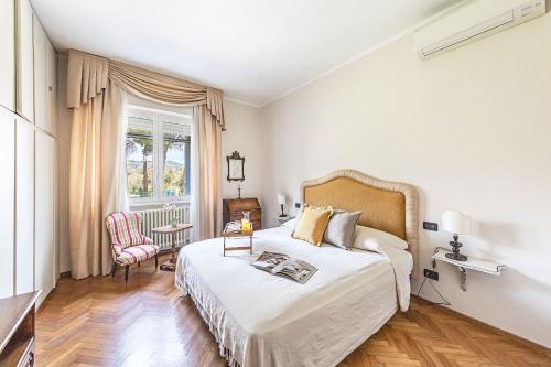a bedroom with a bed and a table and a window at Villa Elisa by Whale Homes in Padenghe sul Garda