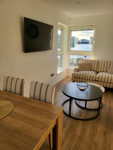 a living room with a couch and a table at Quayside Waters in Dundee
