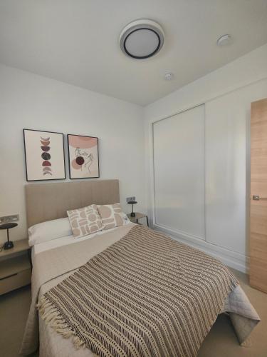 a bedroom with a bed and a large window at La Mosa Sol in San Javier