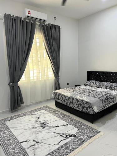 a bedroom with two beds and a window with curtains at Alaisya Homestay in Kampung Raja
