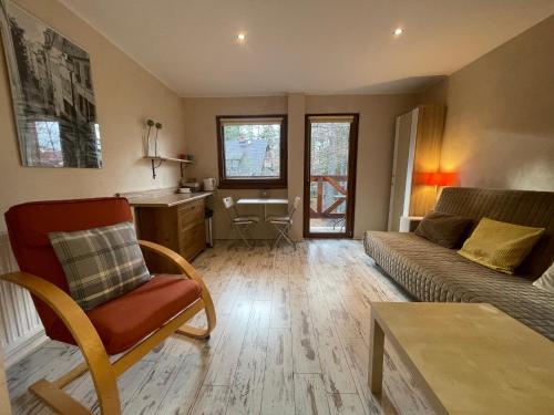 a living room with a couch and a table at Willa Avita in Karpacz