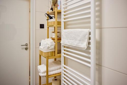 a bathroom with a towel rack with towels at Großzügiges Studio-Apartment in Dresden