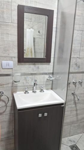 a bathroom with a sink and a mirror at Departamento Tunuyan in Monte Hermoso