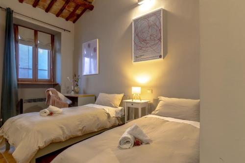 a bedroom with two beds and a window at Altobelli Apartment in Rieti