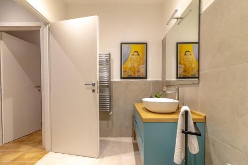 a bathroom with a sink and a mirror and a toilet at Altobelli Apartment in Rieti