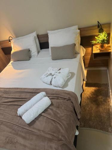 a large white bed with two towels on it at Cristal Park Hotel in Cristalina