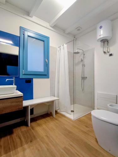 a bathroom with a blue cabinet and a shower at Jazz House in Solanas