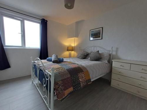 a bedroom with a bed and a window at Lavender lane cottage in Tralee