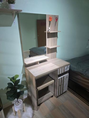 a dressing table with a mirror in a room at 103 Lovely AC apartment with private kitchen in Bangkok