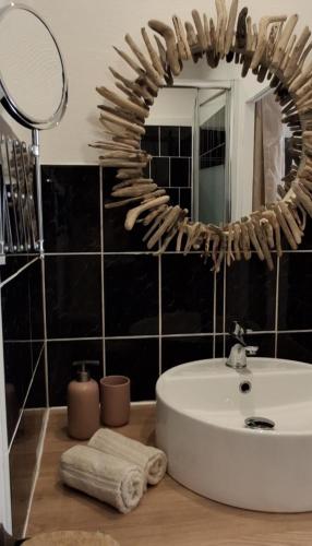 a bathroom with a white sink and a mirror at A Casa Faggia in Sollacaro