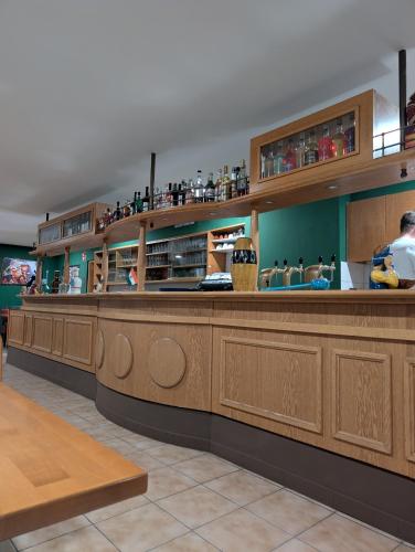 a bar in a restaurant with wooden cabinets at Hotel Shiva in Maingründel