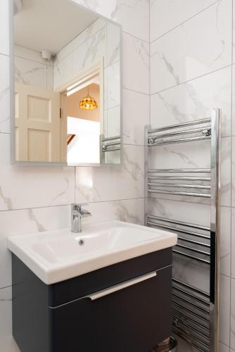 a bathroom with a sink and a mirror at Ashe Street in Clonakilty