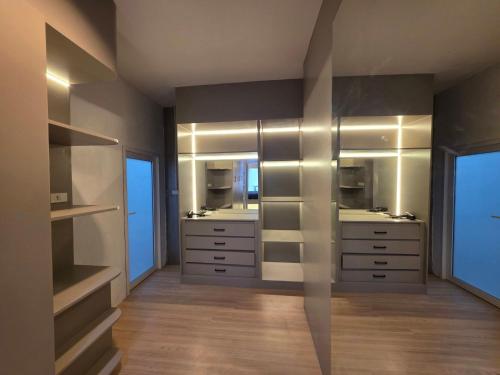 a bathroom with two sinks and two mirrors at Rarin jinda RESIDENCE in Suratthani