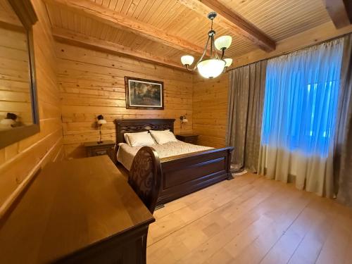 a bedroom with a bed in a wooden room at WOOD house in Skhidnitsa