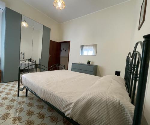 a bedroom with a large bed in a room at Nuova Netum apartment in Noto